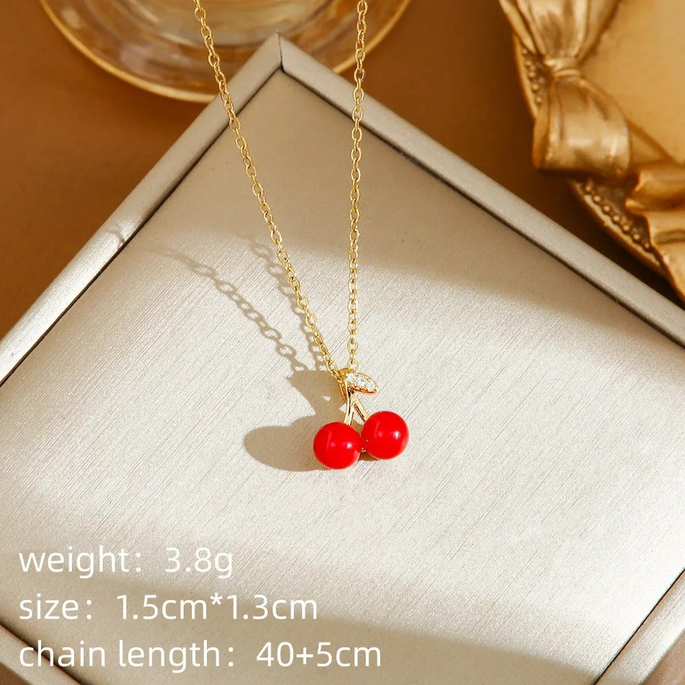 Women's titanium steel necklace with delicate indie pendant designs including strawberry, cherry, and pepper motifs