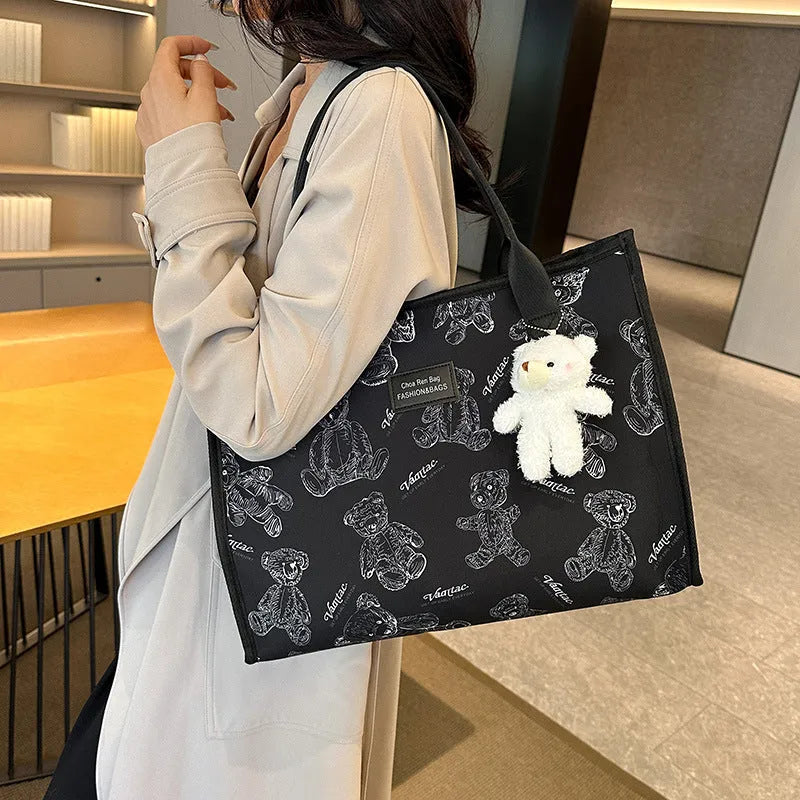 Women's black canvas tote bag with rhombus pattern print and shoulder strap