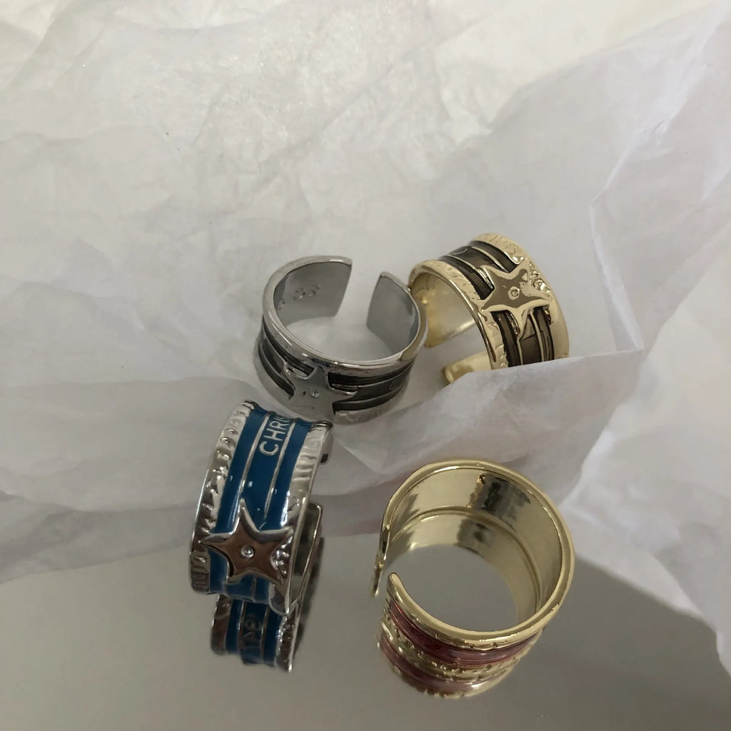 Adjustable geometric drop oil ring in distressed copper, shown in multiple colour options.