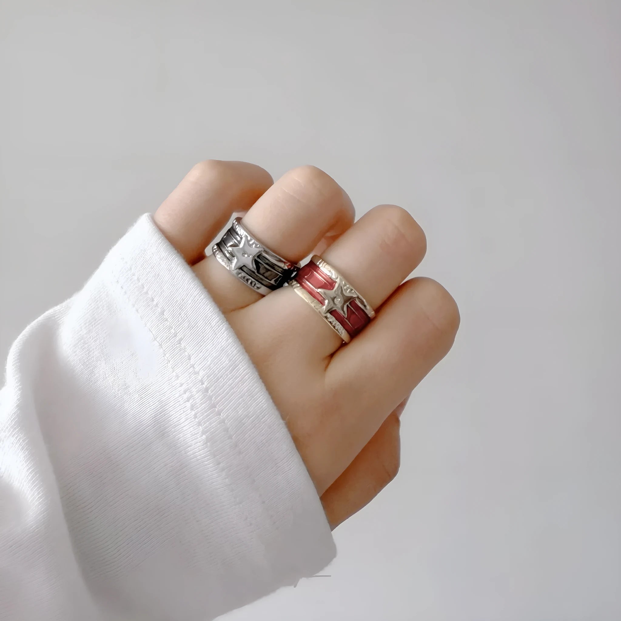 Adjustable geometric drop oil ring in distressed copper, shown in multiple colour options.
