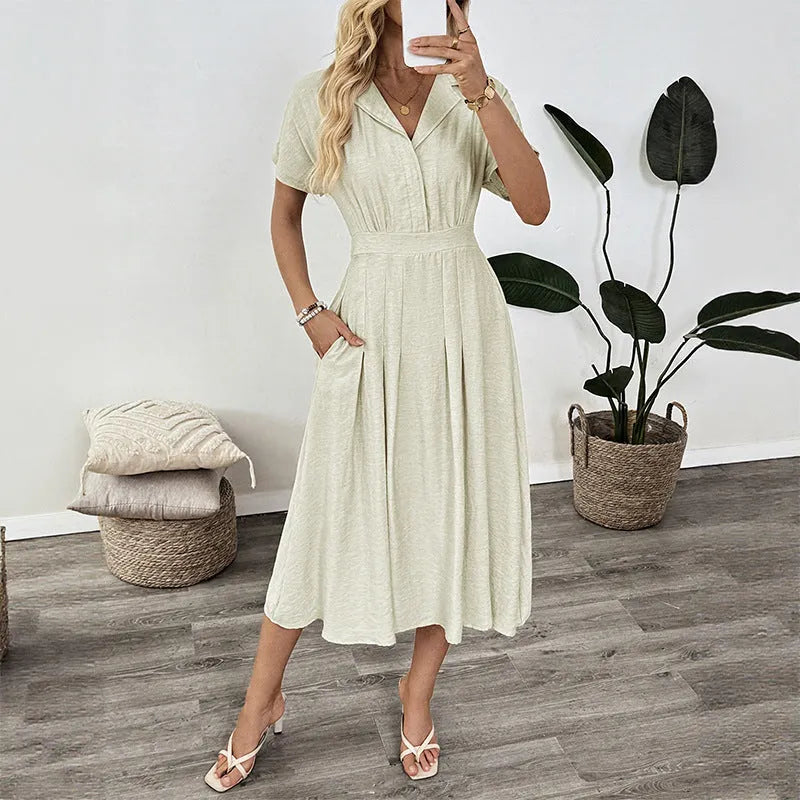 Light green women's shirt dress with lapel collar, waist tie, and skirt pocket on a hanger.