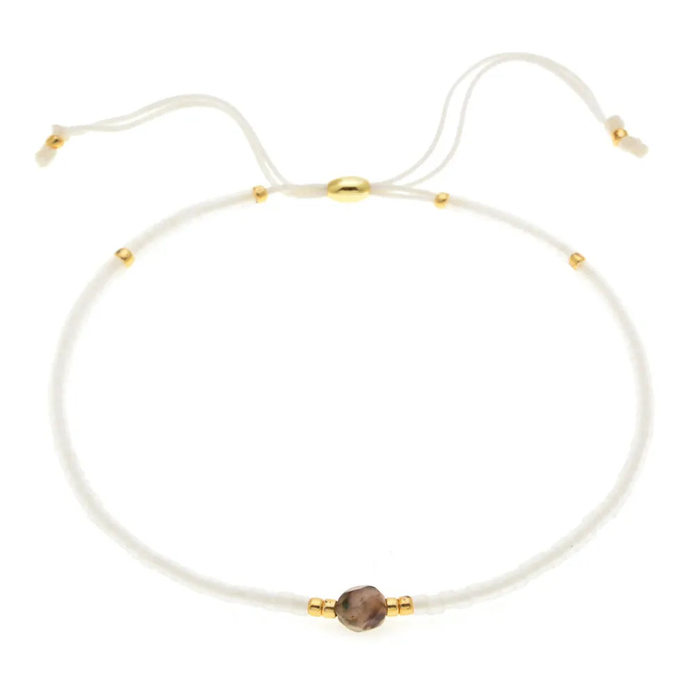 A colourful Bohemian style beaded bracelet with semi-precious stone and glass beads on an adjustable strap.