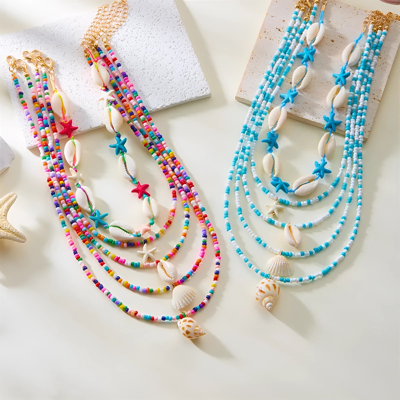 Women's multi-layer necklace set with blue shell pendants and beads, showing five coordinated designs
