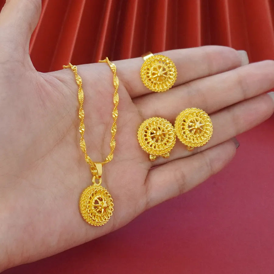 Gold-plated three-piece jewellery set with necklace, earrings, and ring in a floral design.