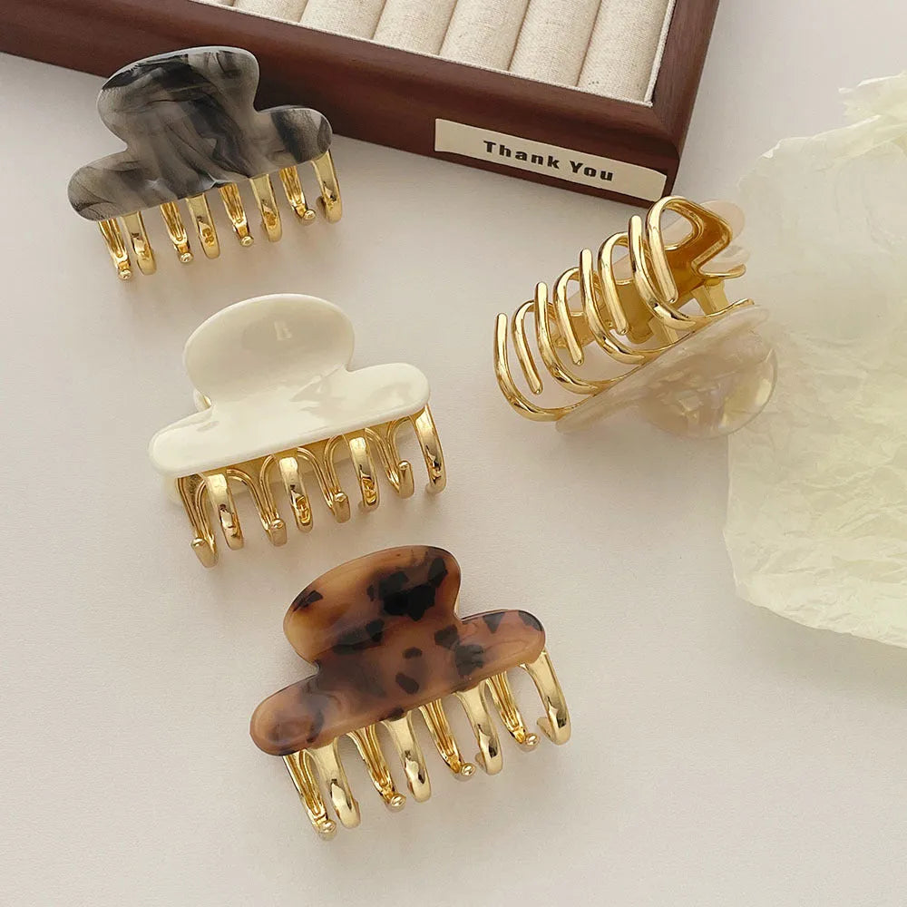 A medium-size retro-style hair barrette with a metal grip, in an alloy acrylic construction.