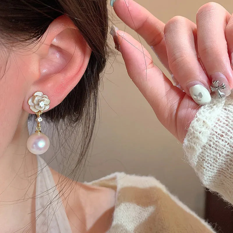 Camellia flower shaped stud earrings in alloy metal with floral design details