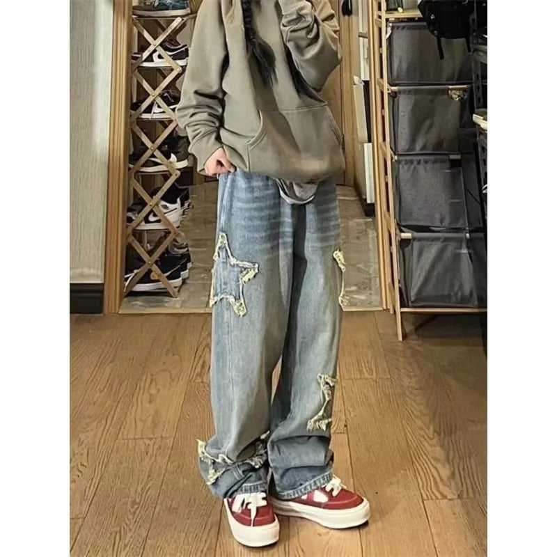 Blue women's straight-leg jeans with a high waist on a hanger, showing the denim texture and cut.