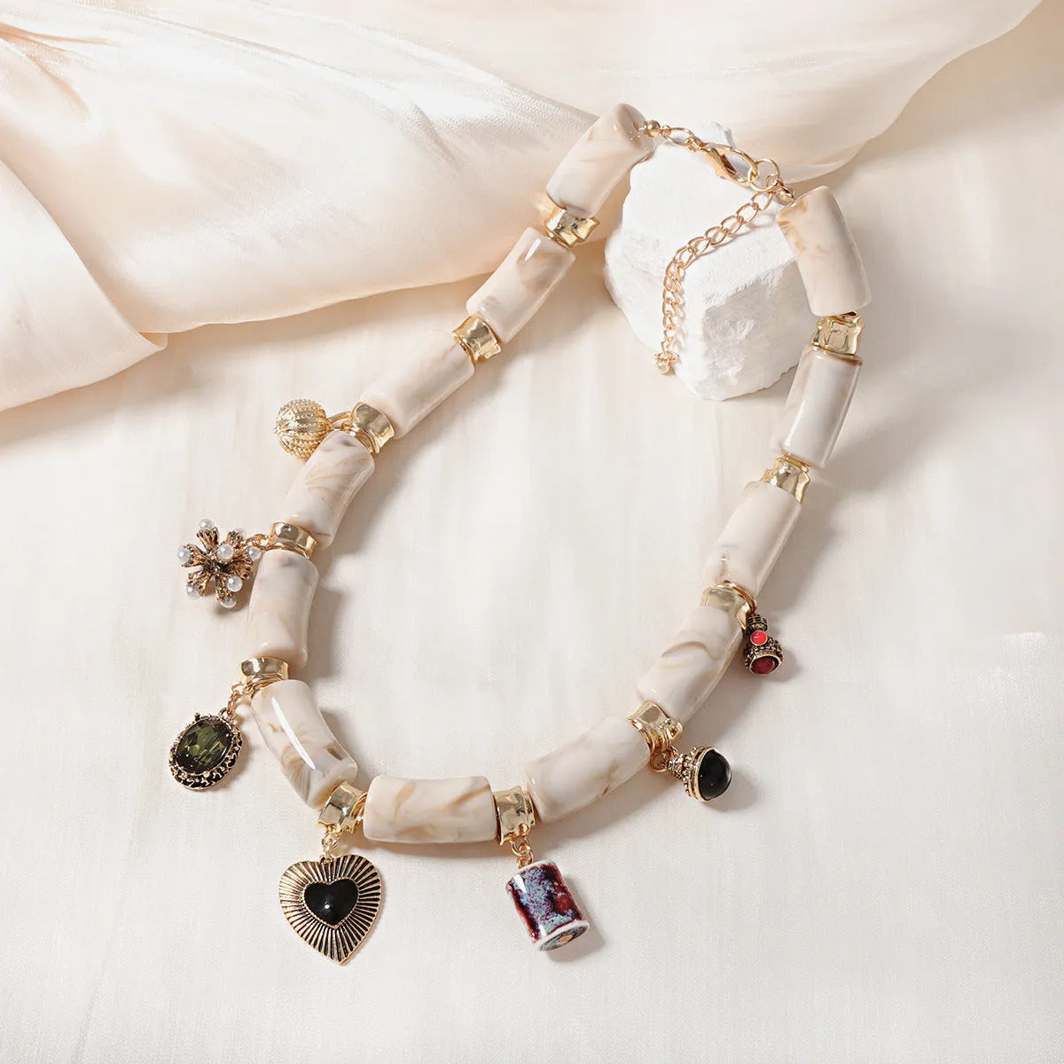 Close-up of a heart-shaped bamboo motif pendant necklace for women on an electroplated chain.