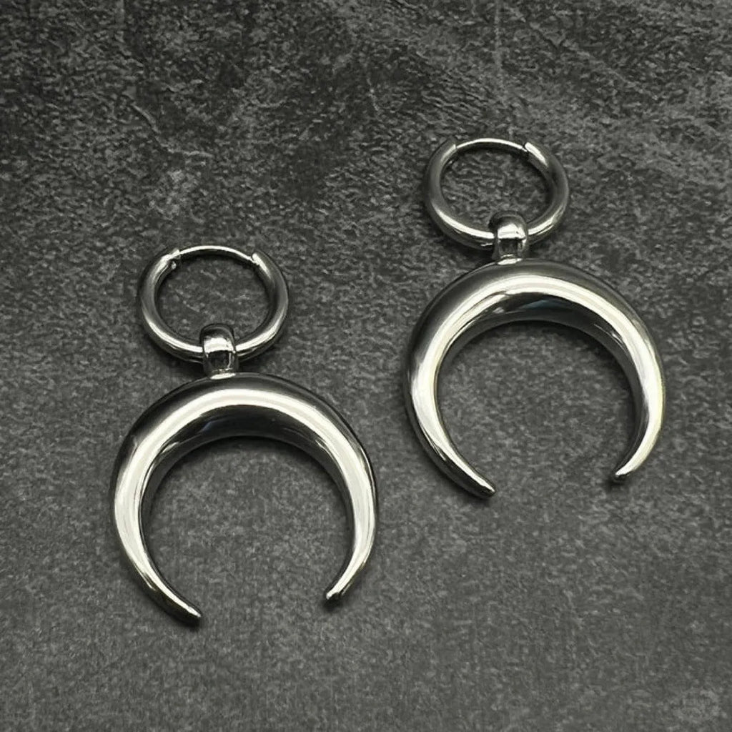 Silver-colour large hoop earrings with moon detailing and geometric shape on ear clip fastening