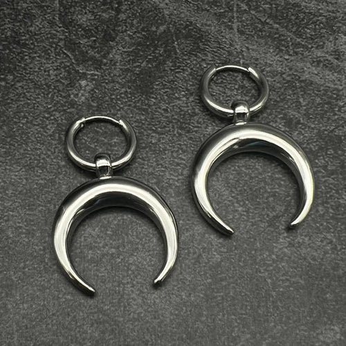 Silver-colour large hoop earrings with moon detailing and geometric shape on ear clip fastening