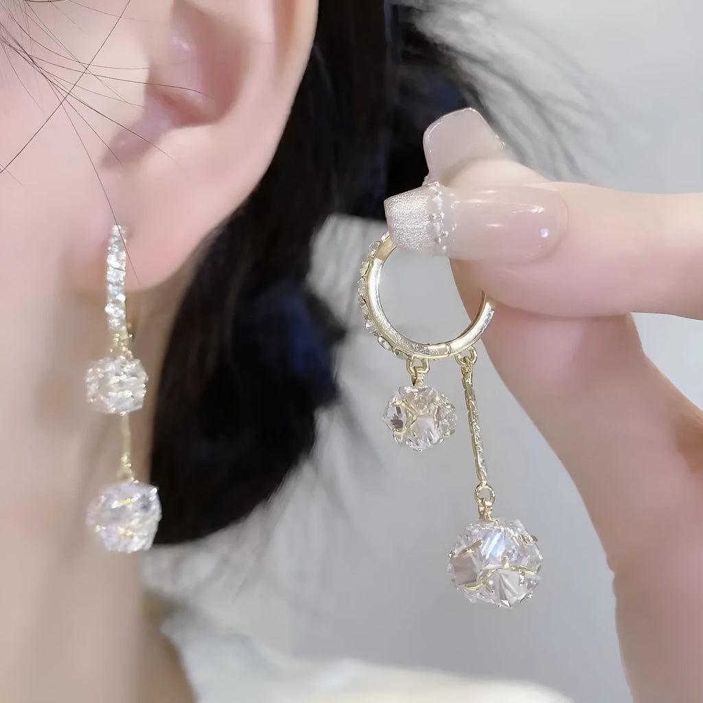 Silver tone clip-on earrings with tassel ball and rhinestone ball pendants in drop design