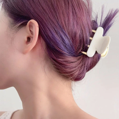 A medium-size retro-style hair barrette with a metal grip, in an alloy acrylic construction.