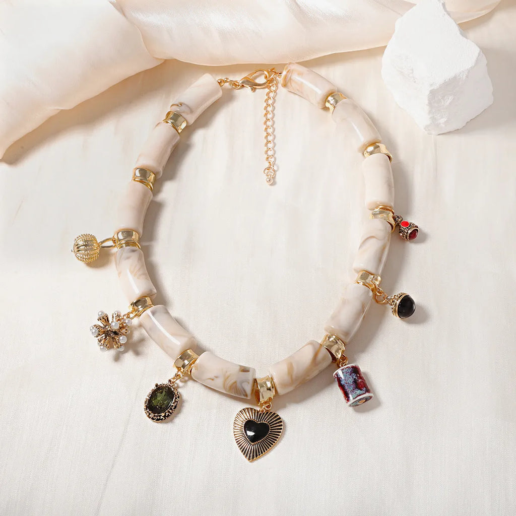 Close-up of a heart-shaped bamboo motif pendant necklace for women on an electroplated chain.