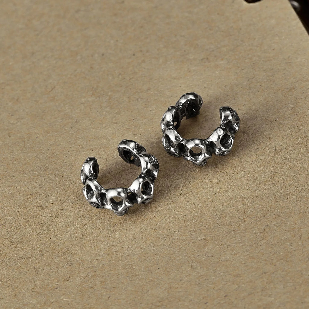 Retro hollow skull design stainless steel clip-on earrings with silver tone finish