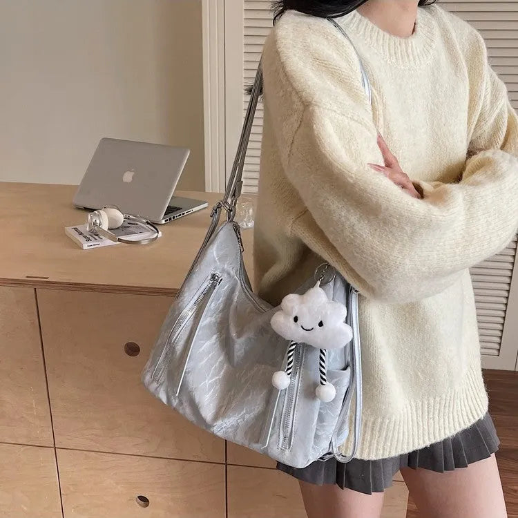 Soft black women's fashion backpack made from wear-resistant PU material, shown with a matching pendant.