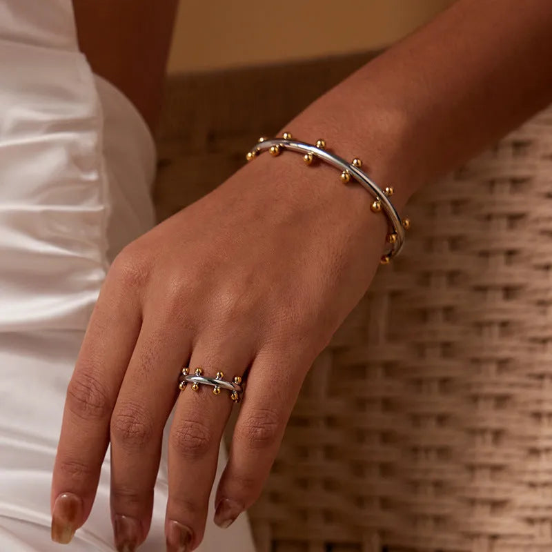 Stainless steel C-shaped rivet bean bead bracelet with alloy chain fastening in gold or steel colour