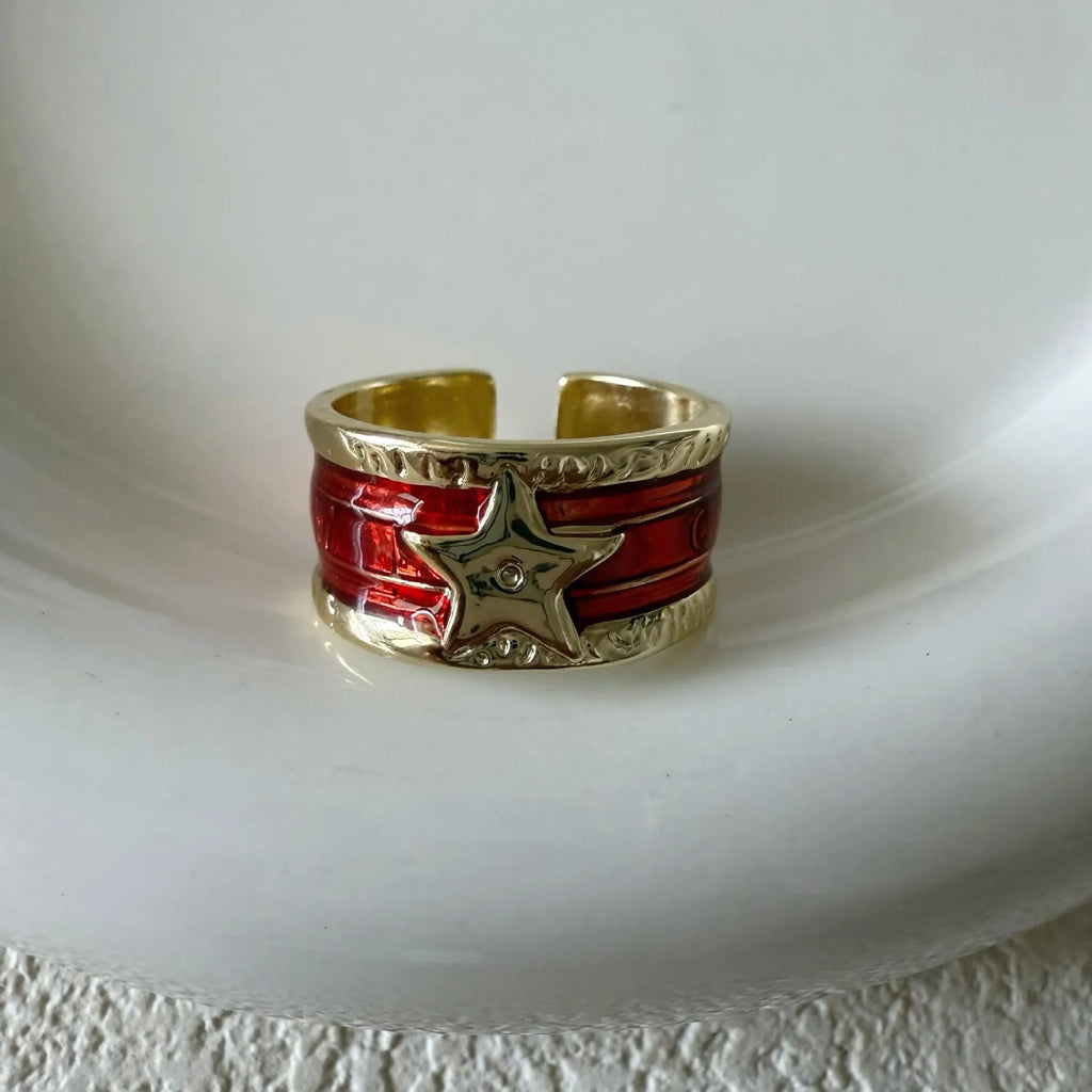 Adjustable geometric drop oil ring in distressed copper, shown in multiple colour options.