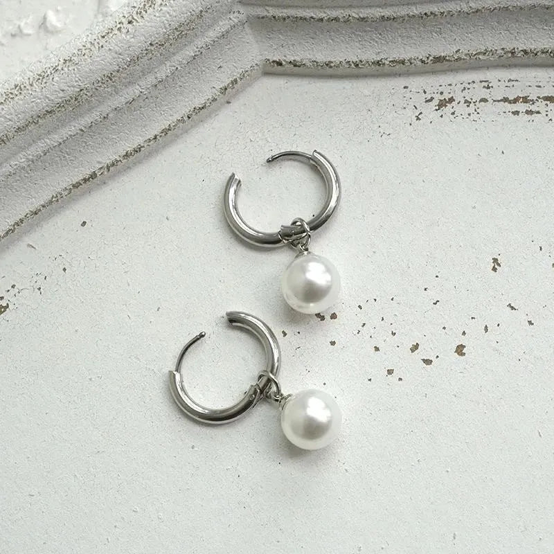 Pair of pearl-coloured geometric round drop earrings made from titanium steel alloy