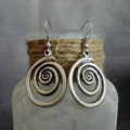 Silver geometric spiral distressed earrings showing alloy construction and 5cm drop length