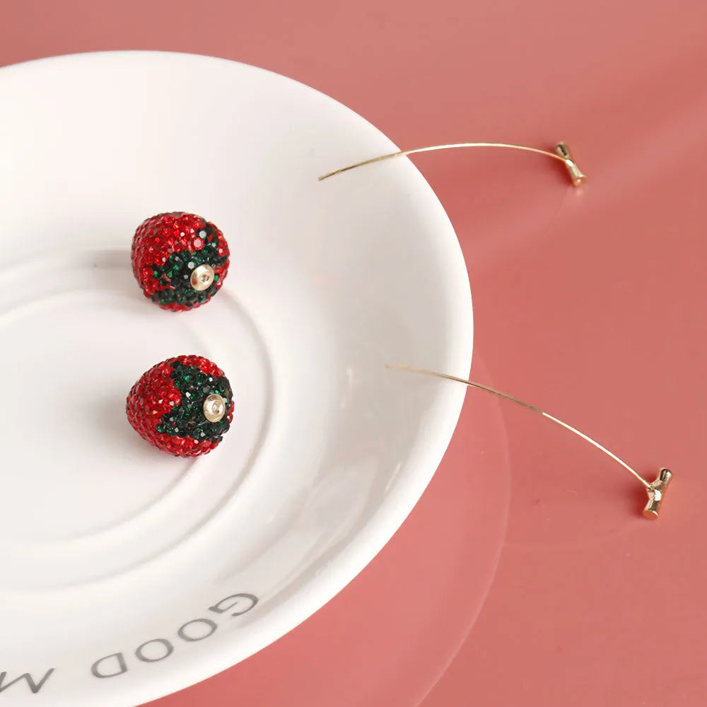 Red geometric strawberry earrings with spot drill detailing on zinc alloy