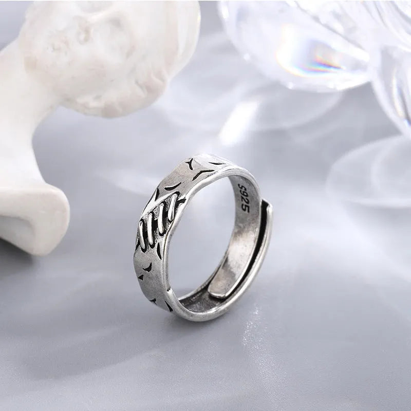 Geometric adjustable ring in matte black copper with round and oval design elements