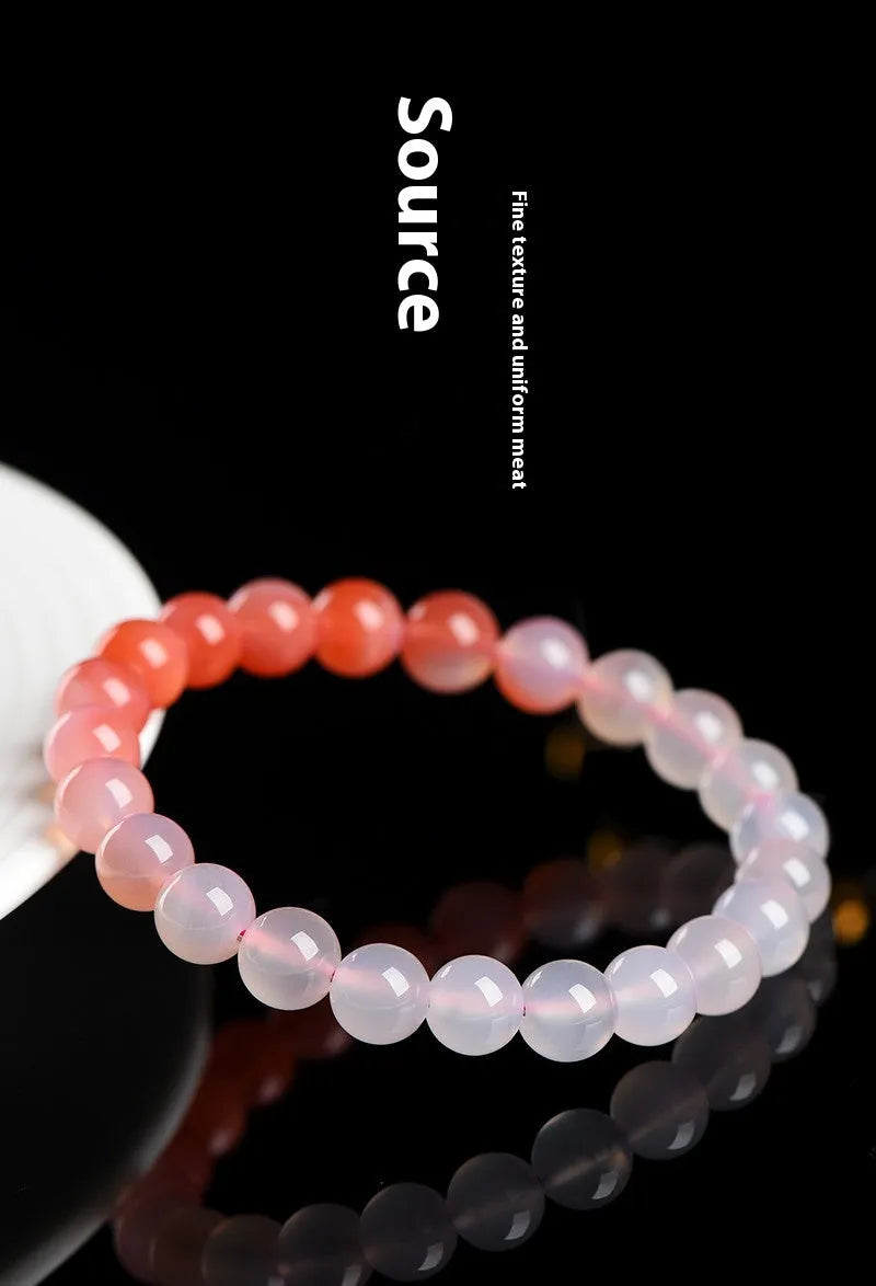 Natural gradient colour agate bracelet with geometric beads on a wrist.