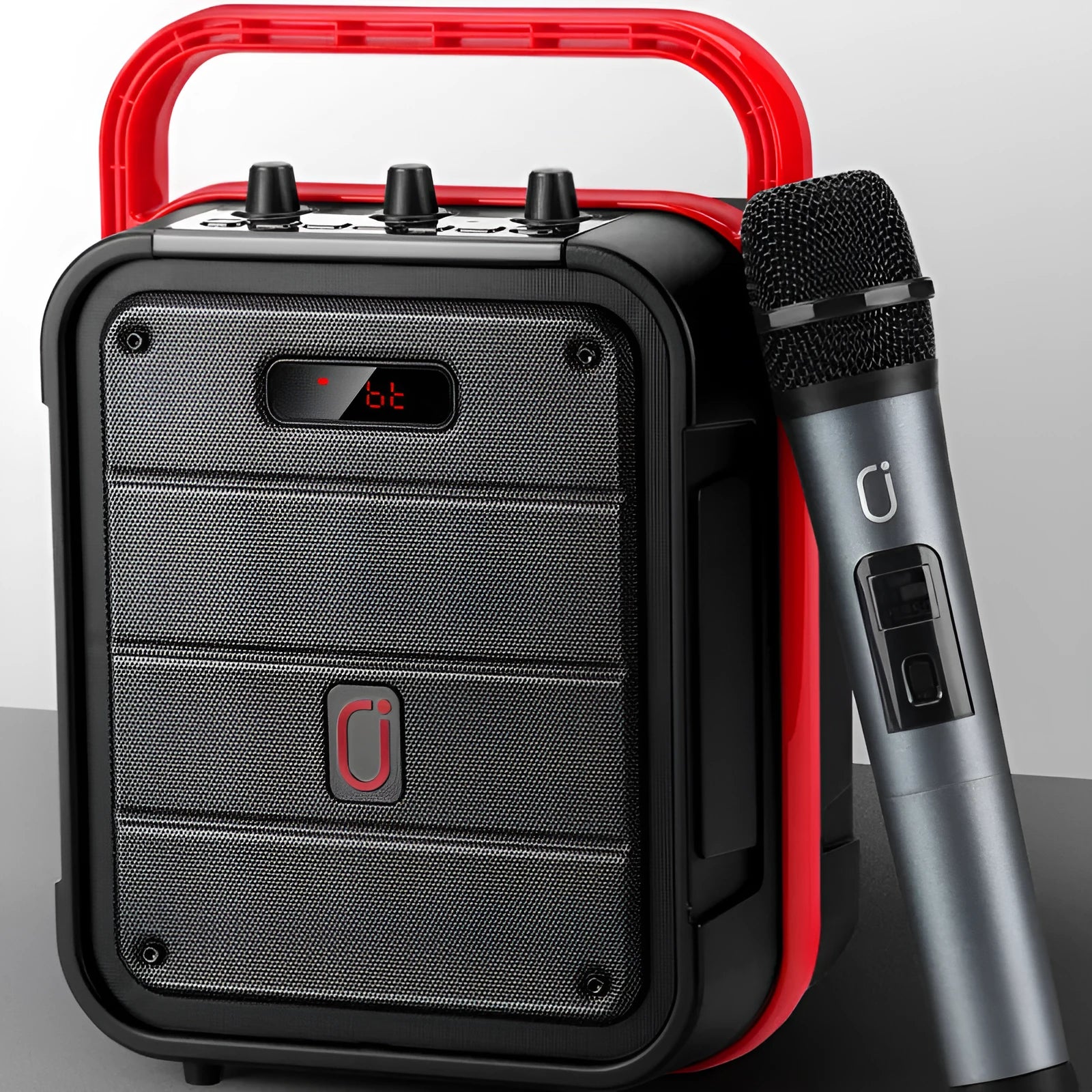 MS62AI portable Bluetooth speaker with wireless microphone and remote control on a table.
