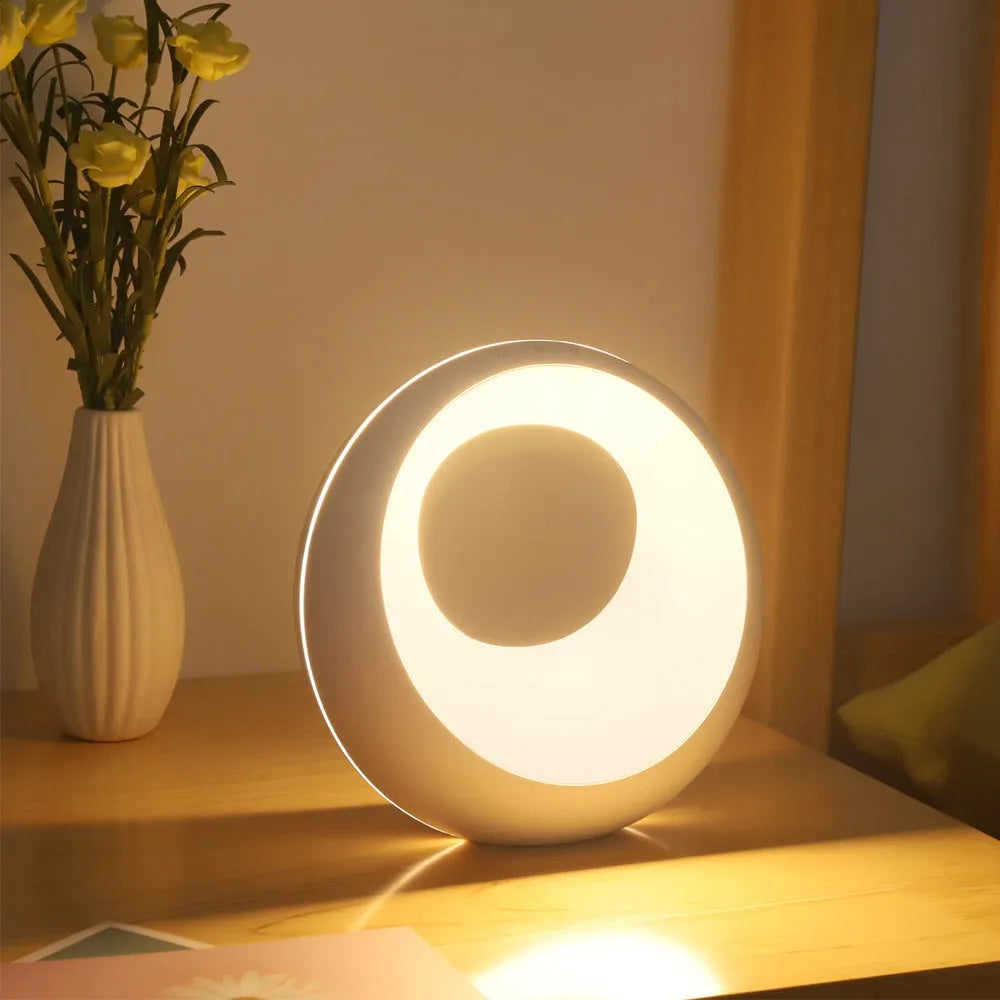 Small RGB colour changing night lamp with remote control on bedside table