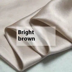 Double-sided silk duvet cover in bright brown colour, shown on a bed.