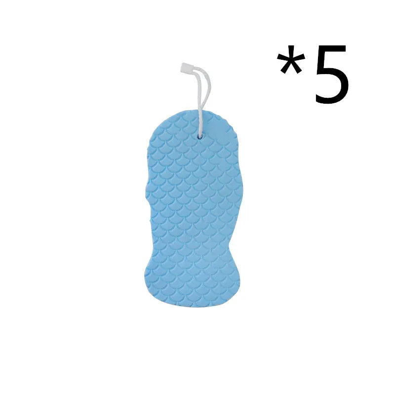 White 3D fish scale pattern bath sponge ball on a bathroom surface
