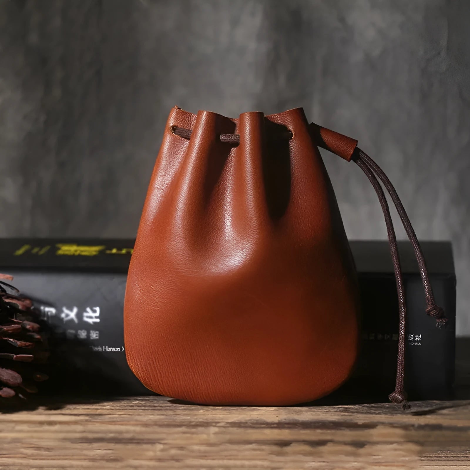 Vintage cowhide drawstring bundle wallet in genuine leather showing retro style and sewing thread detail.