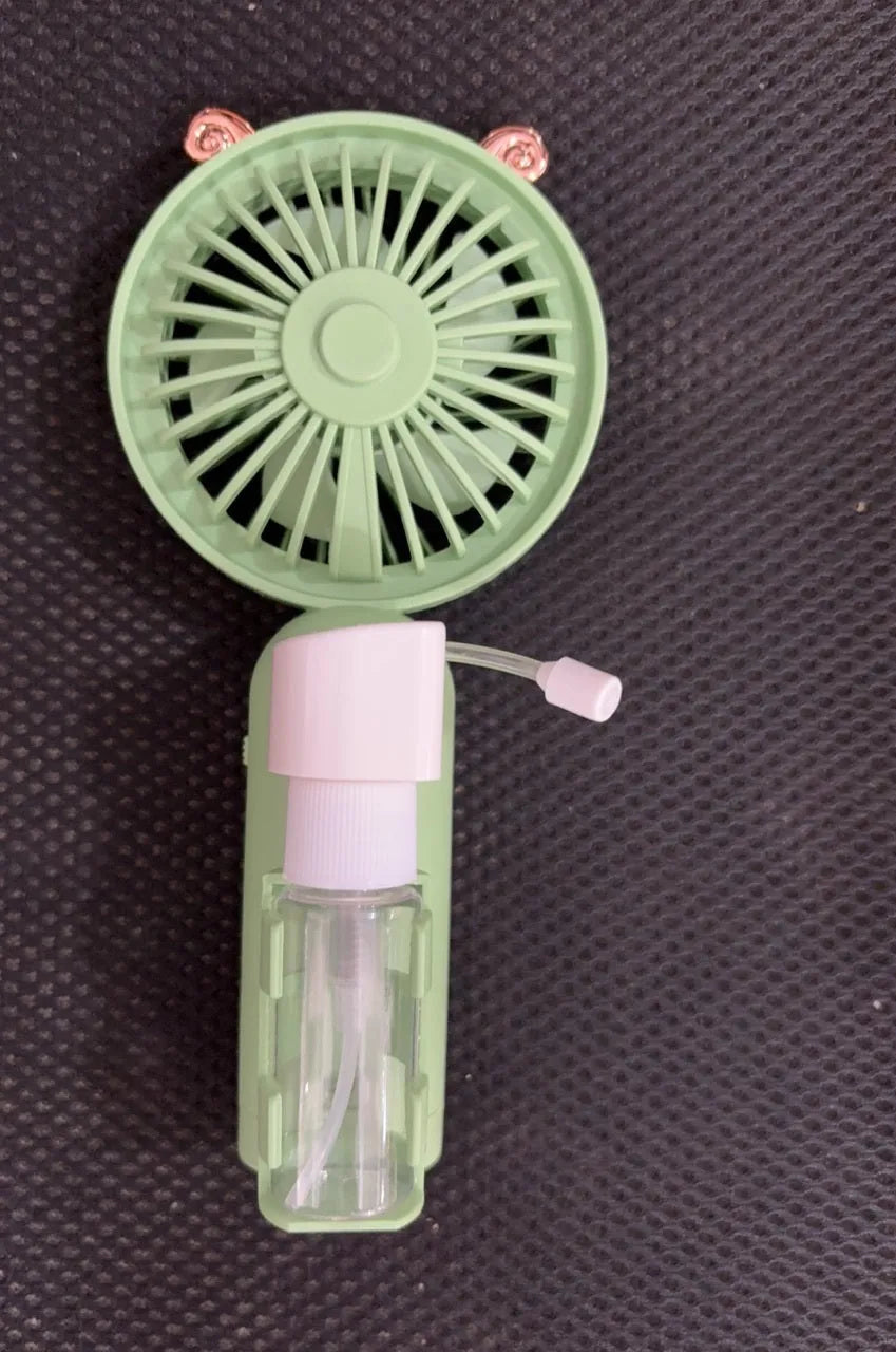 Personalised plastic handheld desk fan with USB port in apricot colour, showing scale.