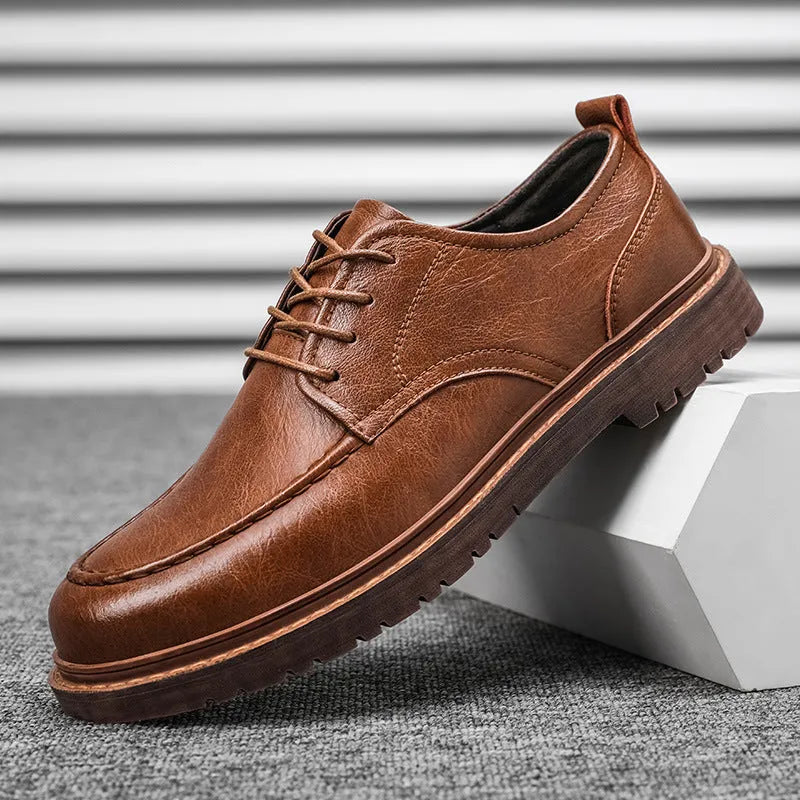 Men's black and brown casual leather shoes with round toe, low top, and flat rubber sole