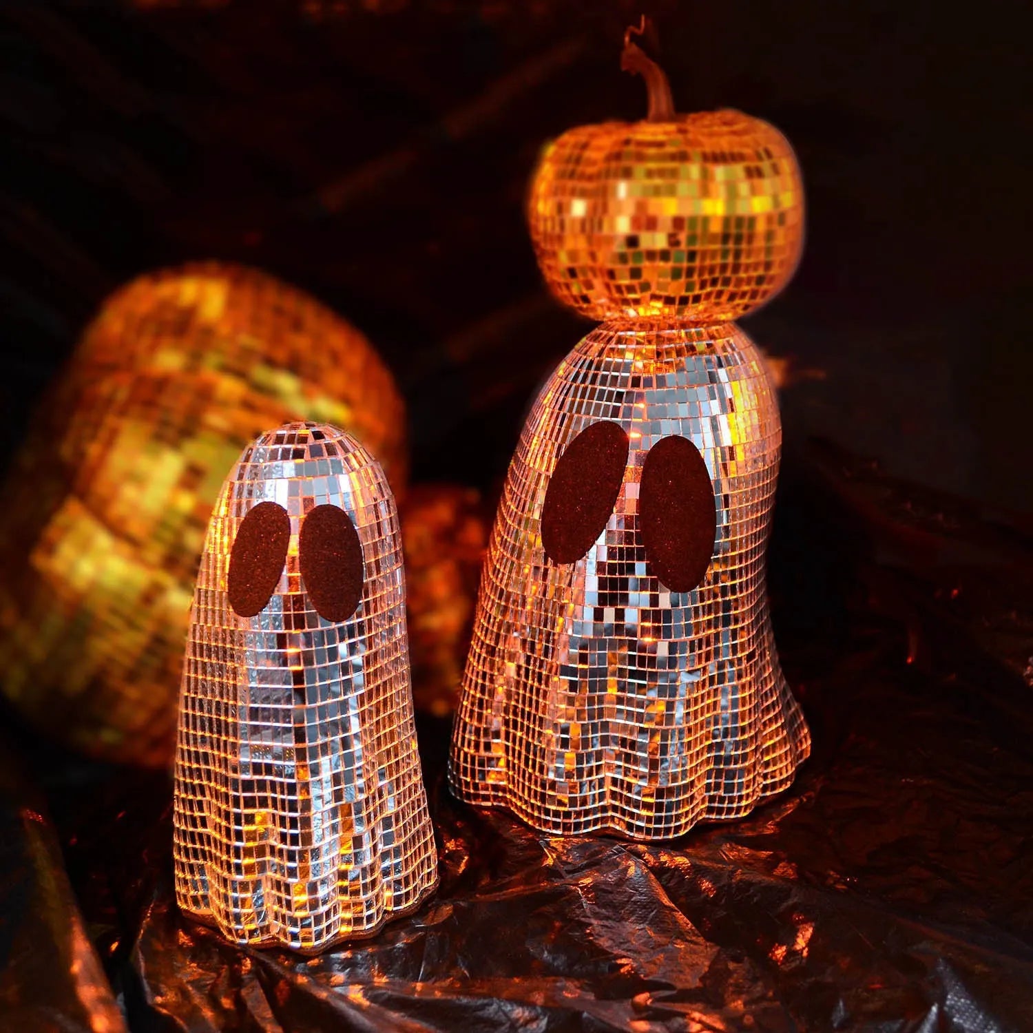 Silver Halloween ghost decoration with glass mosaic mirror patch design on dark surface