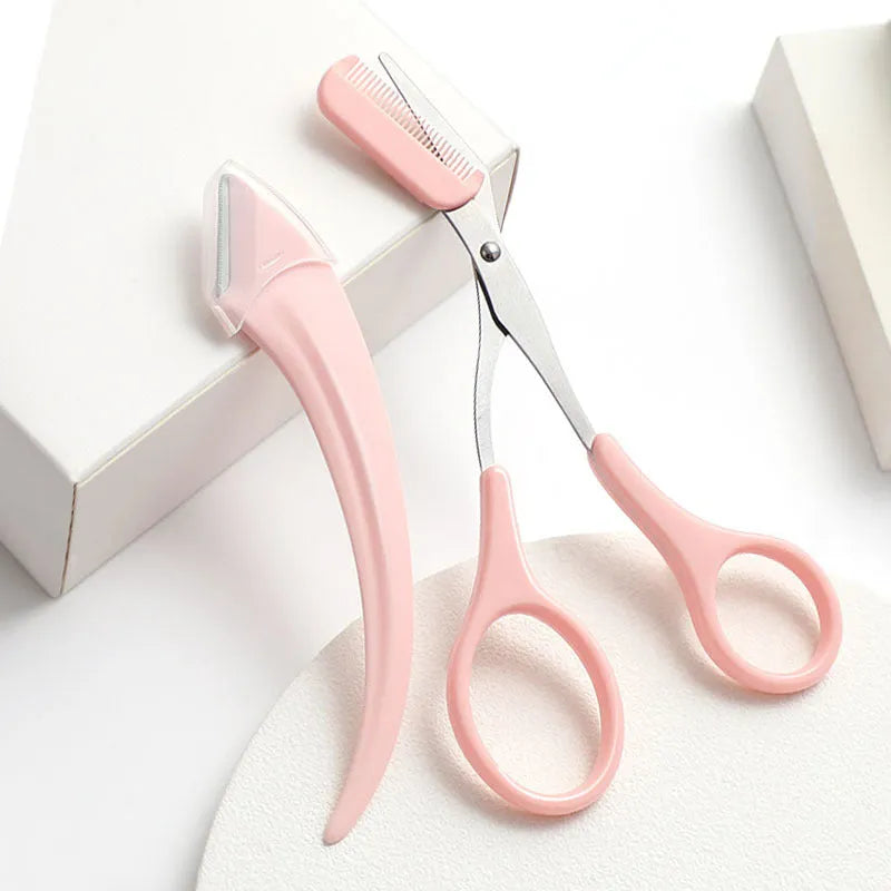 Close-up of a pink and white eyebrow trimming knife with a curved blade and a small comb on a white background.