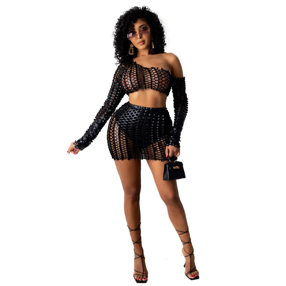 Women's black hollow-out net two-piece dress set with sleeveless top and short skirt.