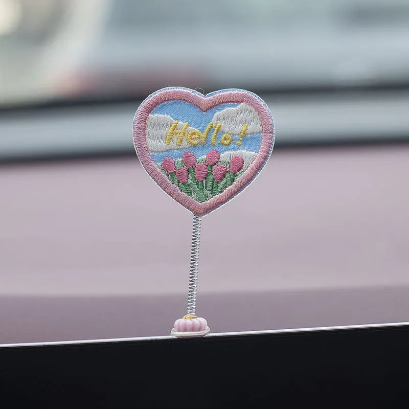 Set of six small cartoon duckling figures and one hello sign for car dashboard decoration.