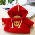 A small dog wearing a blue cloth hoodie sweater from the range of six available colours.