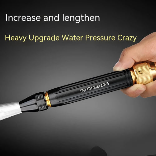 Black car wash gun with straight spray design and alloy body next to a garden hose.