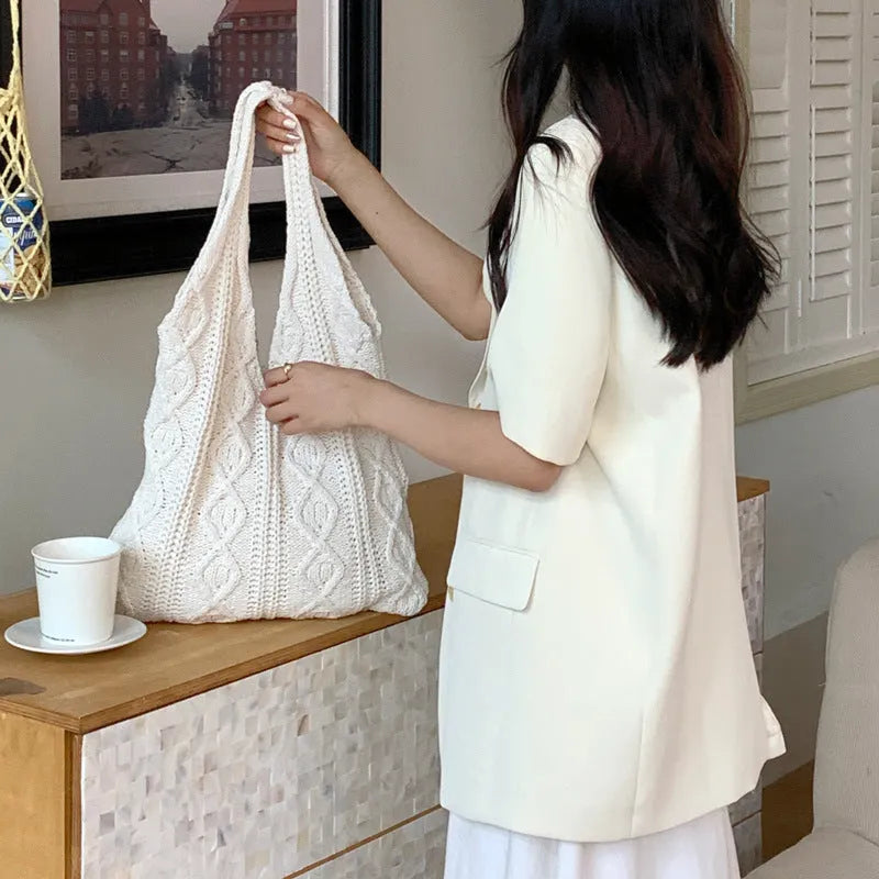 Knitted wool yarn shoulder tote bag with hollow crochet design in solid colour