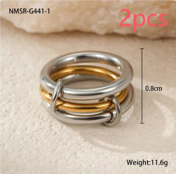 Stacked gold plated stainless steel ring set with exaggerated design on hand