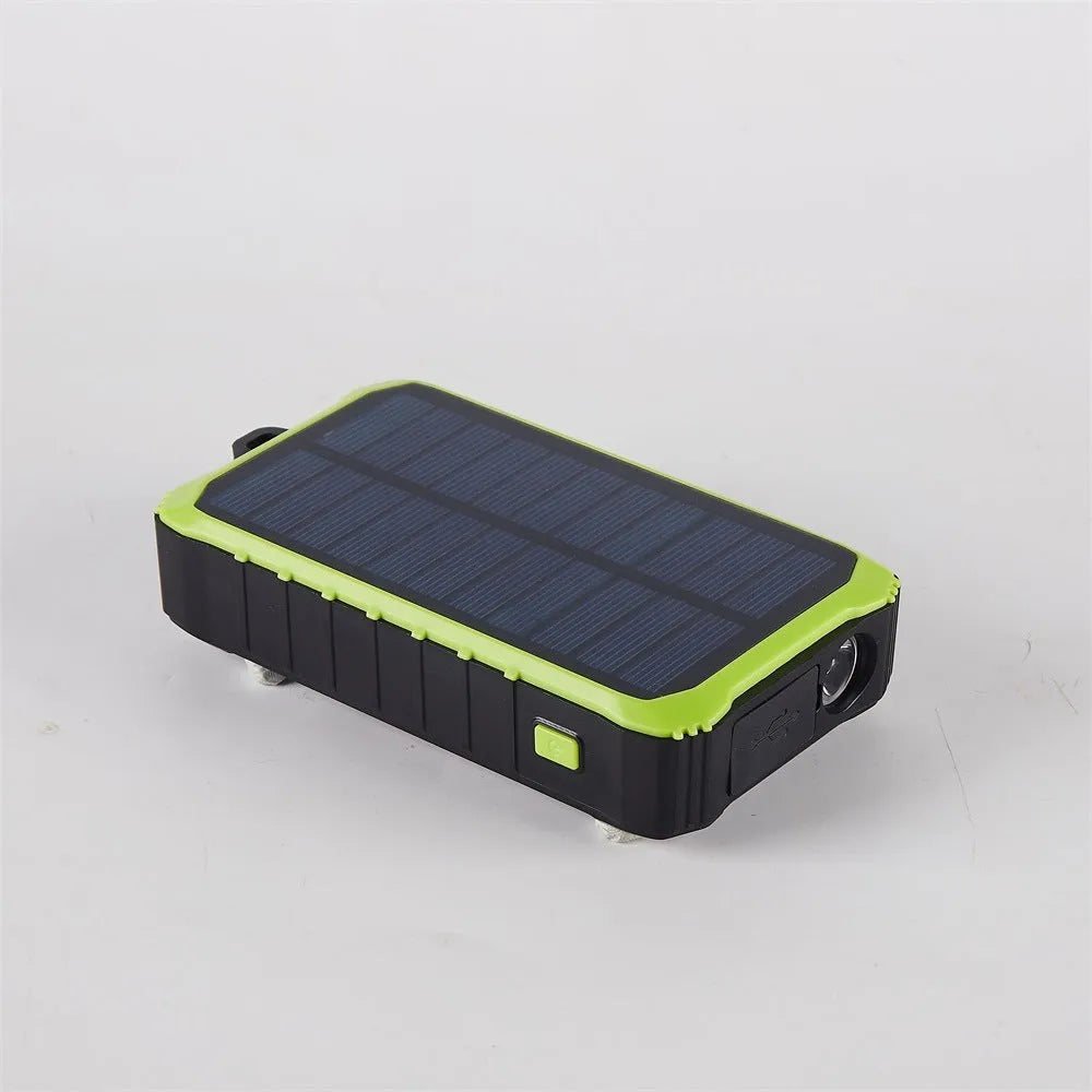 Orange and green portable solar hand crank power bank with USB ports and LED light