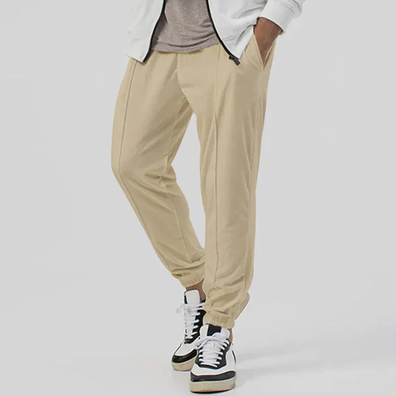 Men's loose tapered casual sweatpants in a grey cotton blend fabric with an elastic waistband.