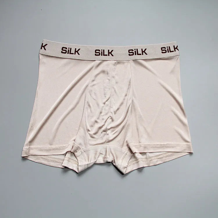 Men's loose silk shorts in navy blue, showing mid waist and relaxed fit.