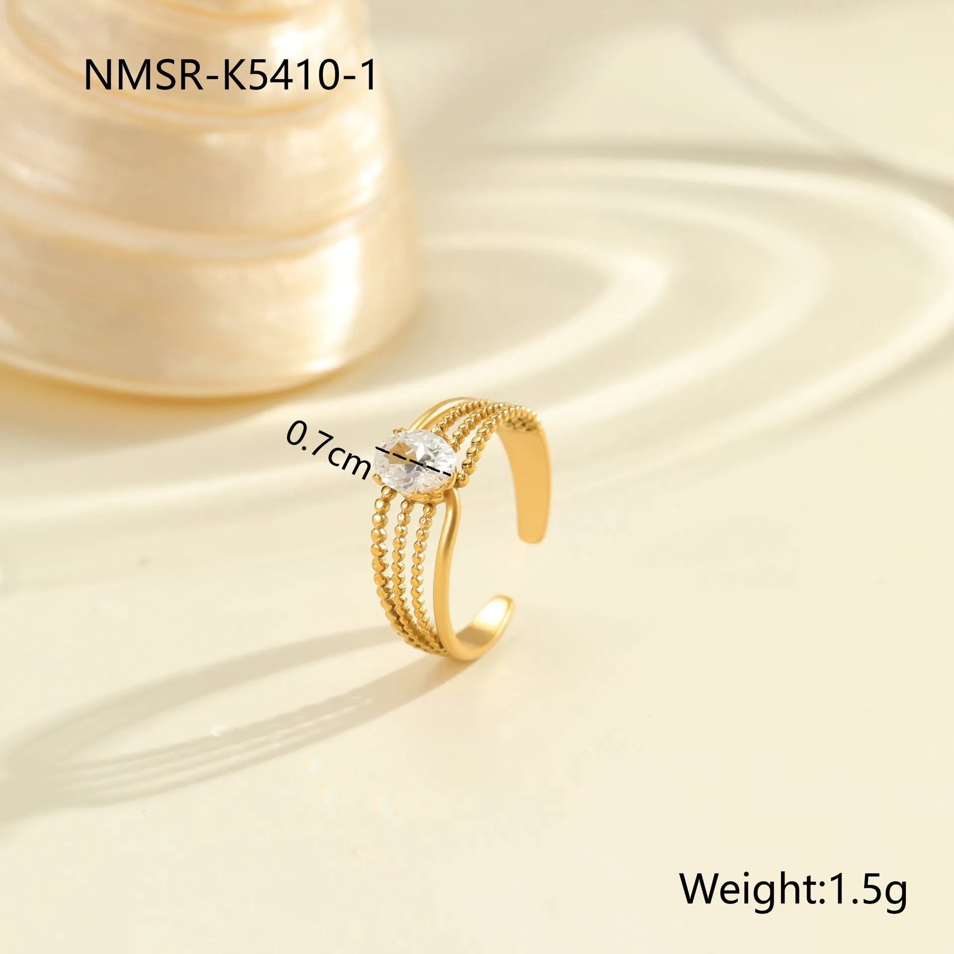Gold inlaid zircon geometric heart and drop shape stainless steel ring on white background.