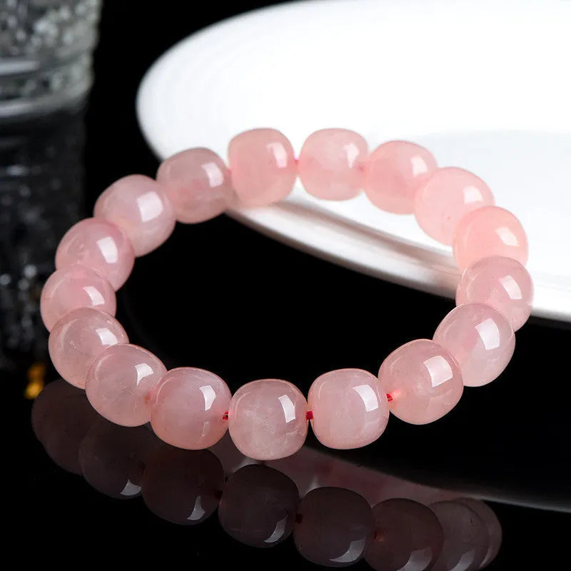 Natural pink crystal barrel bead bracelet with 8x10mm geometric beads on wrist
