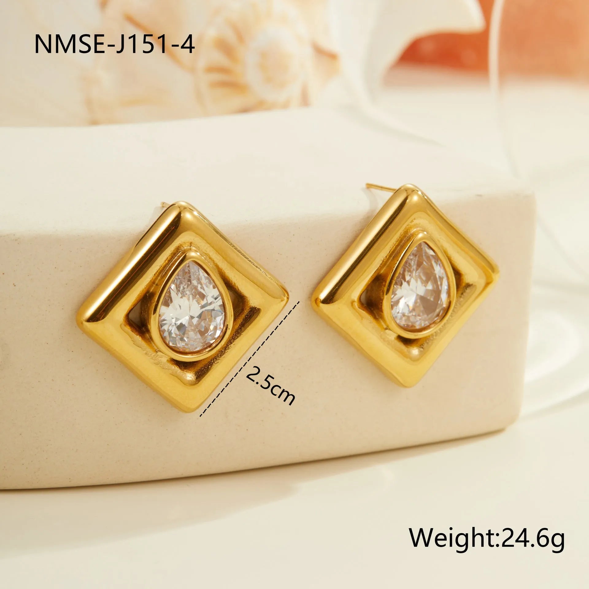 Gold geometric stud earrings with inlaid water drop zircon on white background.