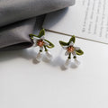 Women's flower ear clip earrings with sterling silver needle flowers and contrast colour alloy metal design