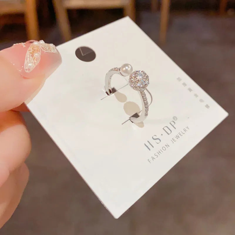 Women's open-end ring with round zircon stones and geometric design in gold or silver finish
