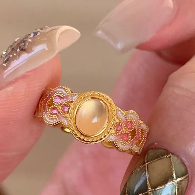 Geometric pink crystal enamel open ring with gold plating showing adjustable design